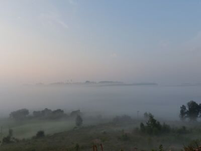 Blick über die nebligen Täler auf Bergkuppen.